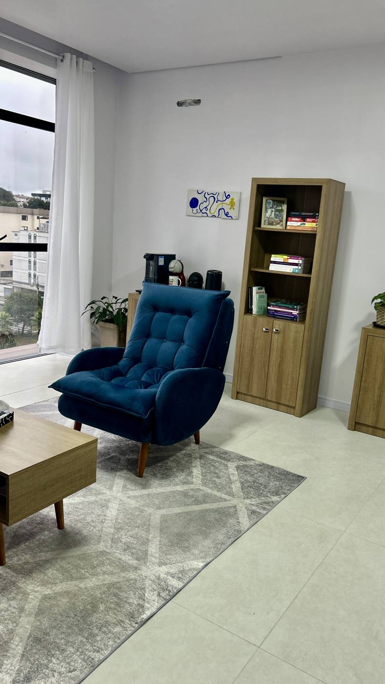 Sala de psicoterapia iluminada, com plantas e sofá
